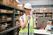 © offsuperphoto - factory worker working on laptop computer in the warehouse storage