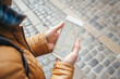 © sattawat - Traveller's hands holding smartphone open map application
