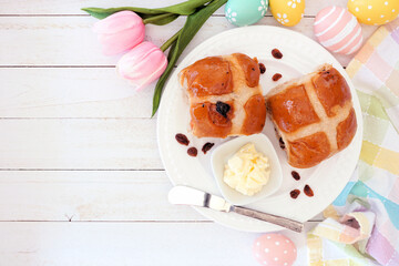 Poster - Fresh homemade Hot Cross Buns on a plate. Top down view table scene on a white wood background. Easter food concept.