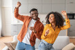 © Prostock-studio - Joyful african american spouses having fun dancing in living room