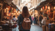 © Adin - Young traveler with backpack wanders through bustling market street, absorbed in local culture. Concept travel tourism trip in bazaar Arab country or Egypt.