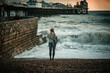 Single sea wave spectator on a Brighton beach on stormy day, East Sussex, England