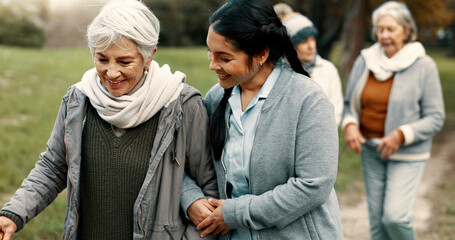 Wall Mural - Happy, walking and a woman and caregiver in nature for talking, support and relax in the morning. Help, together and a young carer speaking to a senior patient in a park or garden for bonding