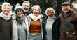 © Clement C/peopleimages.com - Happy, portrait and senior friends in a park while walking outdoor for fresh air together. Diversity, smile and group of elderly people in retirement taking picture and bonding in a forest in winter.