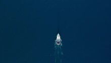 White Sailing Yacht In The Middle Of The Boundless Sea With Calm Water. Aerial Top Down View