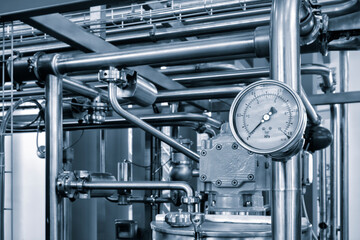 Wall Mural - Industrial  concept. equipment of the boiler-house, - valves, tubes, pressure gauges, thermometer. Close up of manometer, pipe, flow meter, water pumps and valves of heating system in a boiler room.