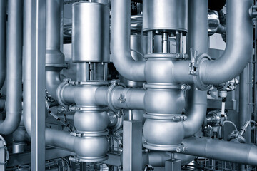 Aufkleber - Metal pipes and containers in an industrial building, view from bottom to top. Industrial concept background