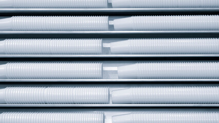 Fototapete - White plastic glasses in a row on a production line as an industrial concept background