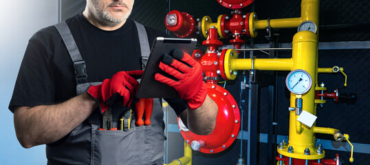 Poster - male factory engineer. technologist with electronic tablet. cropped man near gas pipes. engineer is 