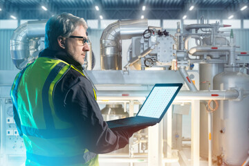 Poster - man factory technologist. engineer works with laptop in his hands. technologist in boiler manufactor
