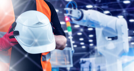 Poster - helmet in hand of industrialist. industrial technologies. hand manipulator behind person. factory em
