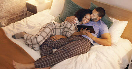 Sticker - Couple, happy and hug in bedroom with tablet at night, streaming movie and relax. Smile, technology and man and woman in bed on social media app, watching online video and bonding together in home.