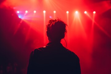 Poster - A lone figure basks in the vibrant glow of a red and blue spotlight, captivated by the electrifying energy of a live concert