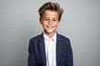 © Inigo - Portrait of a smiling little boy in a suit. Studio shot.