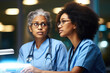 © vefimov - Two women in medical scrubs are focused on laptop screen. This image can be used to illustrate teamwork, collaboration, or technology in healthcare industry