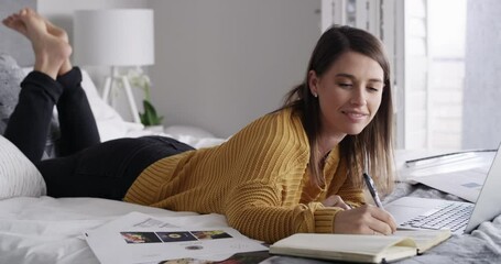 Poster - Woman, laptop and writing or planning in bedroom for work from home and website design project at home. Freelancer relax and thinking of ideas, goals and creative research with notebook on a computer