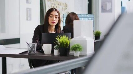 Poster - Asian specialist creating house blueprints with cad software, working in laptop with engineering tools and architectural scale measurements. Woman developer designing sketch for project.