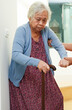 Asian senior woman use walking stick with caregiver help support walking down the stairs prevent accident, slip and fall at home.