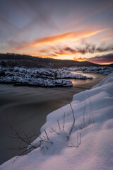 Wall Mural - A colorful long, exposure, sunrise at Great Falls along the Potomac River after a fresh snowfall.