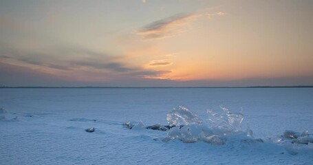 Wall Mural - Sunset over a frozen lake in winter