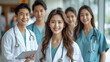 © aekkorn - Medicine and healthcare concept : Asian doctors and Female doctor standing in lobby of hospital on background.