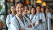 © aekkorn - Medicine and healthcare concept : Asian doctors and Female doctor standing in lobby of hospital on background.