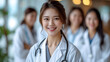 © aekkorn - Medicine and healthcare concept : Asian doctors and Female doctor standing in lobby of hospital on background.