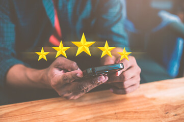 A man customer giving a five star rating on smartphone. Review, Service rating, satisfaction, Customer service experience and satisfaction survey concept.
