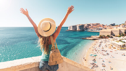 happy woman tourist enjoying view of the old town of dubrovnik in croatia