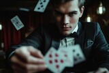 Fototapeta  - Male model in a close-up, perfecting a complex magic trick with cards