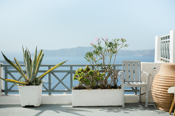 Terrace with potted plants and wooden seat on the Mediterranean Sea