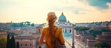 Fototapeta Londyn - Young traveler woman exploring city famous landmarks. Back view of female tourist enjoying historic on sunny vacation day in urban. Caucasian woman touring culture and religion in beautiful cityscape