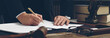 Lawyer working with document at wooden table in office, closeup. Banner design