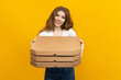 © makedonski2015 - Photo that perfectly represents your restaurant's delivery service. This image of a woman holding pizza boxes on a yellow background is just what you need