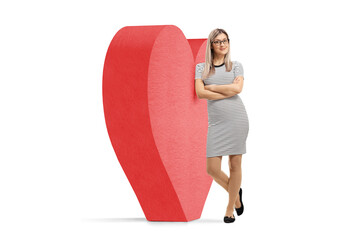 Sticker - Full length portrait of a young blond woman leaning on red heart, dating concpet