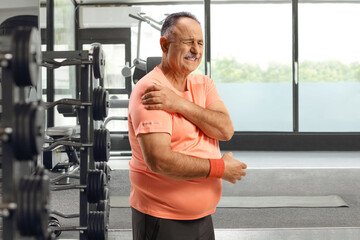 Poster - Mature man at a gym with an injured shoulder