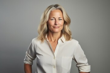 Portrait of a beautiful mature business woman in a white shirt.