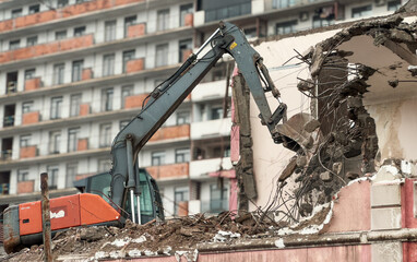 Wall Mural - Excavator demolish or remove old ruined building in rainy day. Old house demolition on construct cite for renovation new housing in modern city.