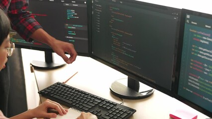 Slow motion back end or software developer manager supervising his team on new application program development on debugging and solving complex code algorithms on monitor. Burgeoning