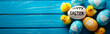 Festive Easter banner with colorful eggs and cheerful yellow chicks on a vibrant blue background with copy space. Text on the egg says 