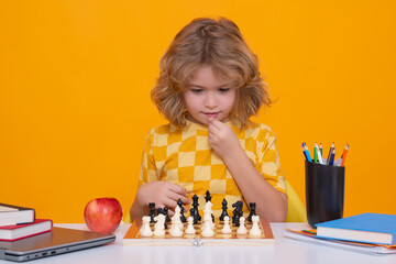 Aufkleber - Child play chess on studio background. Kid thinking about chess. The concept of learning and growing children. Chess, success and winning. Board logic game, kids hobby and lifestyle.
