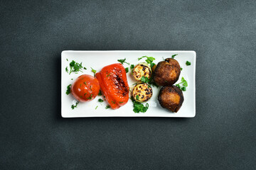 Wall Mural - Grilled vegetables on a plate. Grilled mushrooms, paprika, tomatoes. Meat dishes.