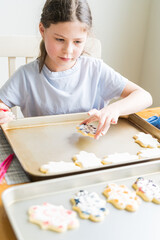 Wall Mural - Little Girl Spells 'Sorry' on Iced Sugar Cookies