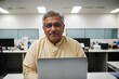 © Portrait Studio - a professional medical expert, sitting in front of a laptop, extends a friendly greeting
