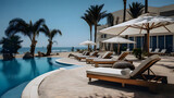 Fototapeta  - Luxurious pool and sun loungers with umbrellas nearby