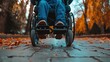 close up Handicapped or old adult man navigates a sidewalk in an electronic wheelchair, city lights in the backdrop Quality of life and impairment concept.