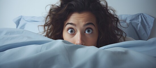 Poster - Funny young brunette woman in bed looking and peeking over sheets surprised. Creative Banner. Copyspace image