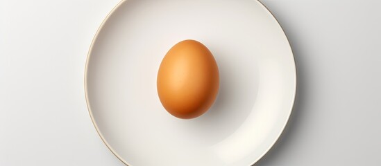 Poster - freshly boiled brown egg on white plate top view. Creative Banner. Copyspace image