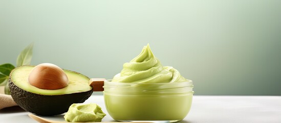 Poster - Fresh avocado puree in a small bowl and wooden hairbrush Homemade face or hair mask natural beauty treatment and spa recipe Top view copy space. Creative Banner. Copyspace image