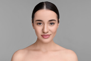 Poster - Portrait of beautiful young woman on grey background